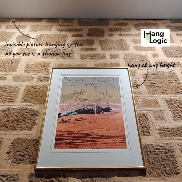 ArtiTeq Shadowline Masonry Sandstone Display Framed desert artwork on sandstone wall hung from hidden ArtiTeq Shadowline Masonry picture rail; only a slim shadow line shows