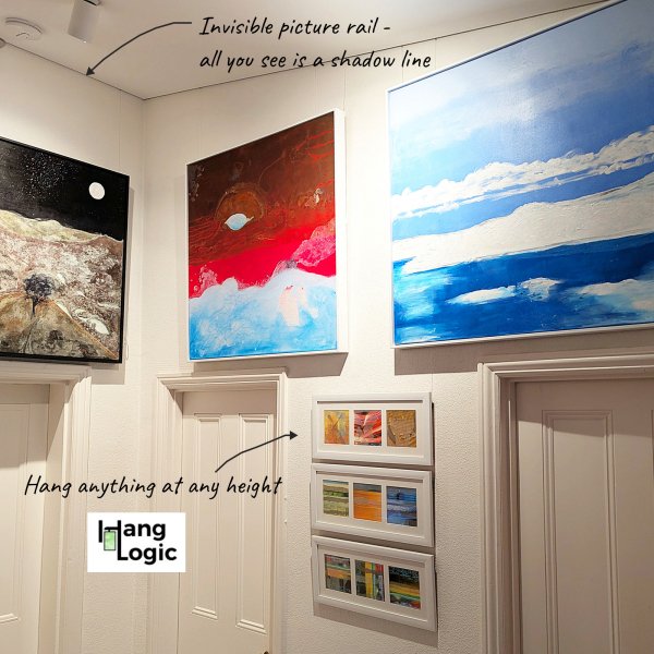 ArtiTeq Shadowline Masonry Corner Gallery Multiple canvases hung at different heights from hidden ArtiTeq Shadowline Masonry picture rail; only slim shadow line visible