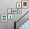 prints hanging in stairwell with artiteq hanging set sloped rail