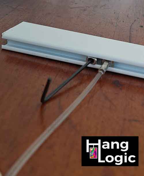 Close-up of a stopper being tightened with an Allen key next to a solid slider to prevent it from sliding.