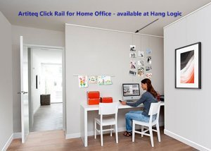 Woman working in a home office with Artiteq Click Rail system for art display, available at HANG LOGIC.