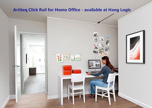 Woman working in a home office with Artiteq Click Rail system for art display, available at HANG LOGIC.
