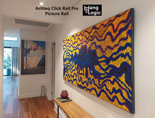 Vibrant abstract painting displayed in a gallery using the Artiteq Click Rail Pro supplied by Hang Logic, seamlessly mounted for a clean, professional look."