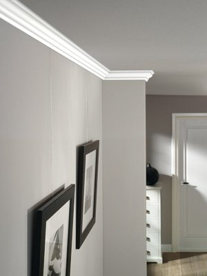 Artiteq picture hanging system behind a cornice in a hallway, offering a flexible and invisible hanging solution – Buy at Hang Logic.
