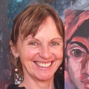 Jacqueline, founder of Hang Logic, smiling with an artwork in the background.