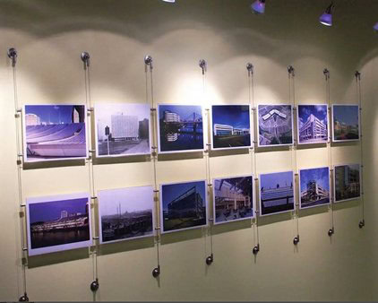 Multiple posters hanging on a wall using the Display IT Fixed system, arranged in a professional and organized manner.
