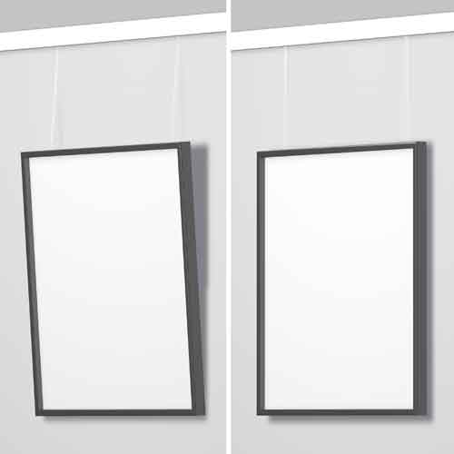 two picture frame hanged on wall, one tilted forward, one hanged flat on wall.