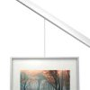 Picture hanging on a slanted wall with wire secured by a stopper. Available at Hang Logic