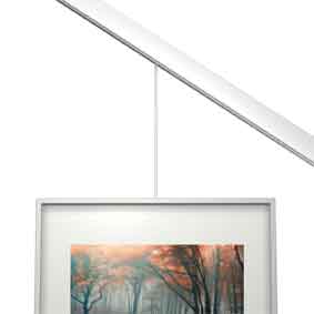 Picture hanging on a slanted wall with wire secured by a stopper. Available at Hang Logic
