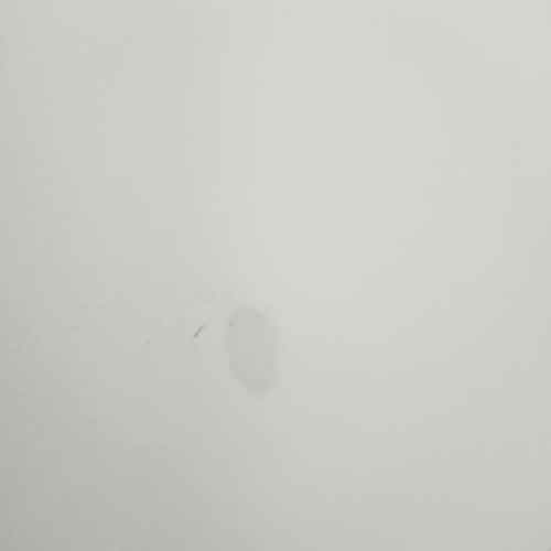 Close-up of a wall with visible damage caused by removing adhesive, illustrating the risks of using temporary hanging solutions.