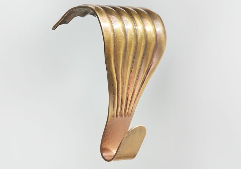 Artiteq decorative brass picture rail hooks with a vintage design, mentioned by Hang Logic for elegant art hanging.