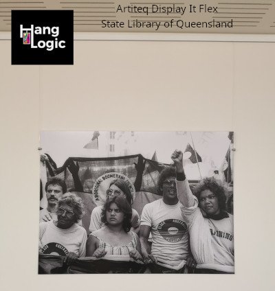 Artiteq Display It Flex system displaying a portrait at the State Library of Queensland, available at Hang Logic.