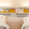 ArtiTeq Info Rail installed above two hospital beds, displaying children’s drawings and cards to create a personalized and uplifting environment. Available at Hang Logic.