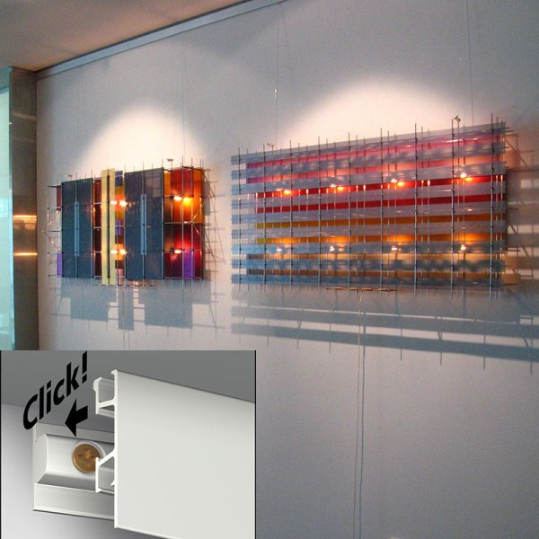 artiteq-click-rail-pro-hang-logic Artiteq Click Rail Pro picture-hanging system for heavy artwork, supporting up to 50 kg per linear meter, displayed with vintage posters, available at Hang Logic.