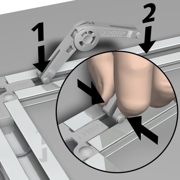 Close‑up of a hand pressing the ArtiTeq PBack Frame Flex Bumper to engage the height‑adjustment pin.