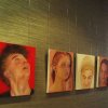 Hotel corridor displaying year‑12 student portraits hung on clear Slider Economy perlon wires, two cables per picture, supplied by Hang Logic.